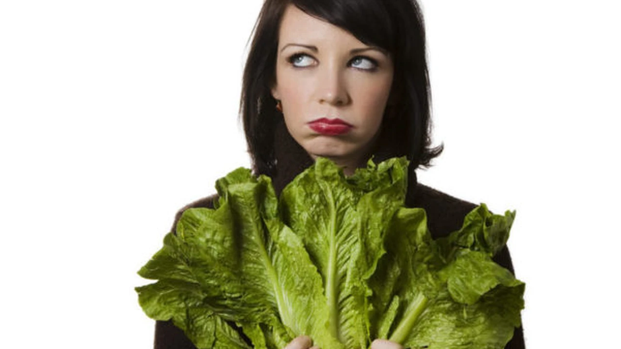Close up on a plate of mashed potatoes, topped with baked pork chops with cream of mushroom soup, and a side of green beans.